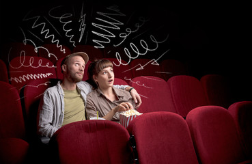 Fototapeta premium Cute couple in cinema watching movie