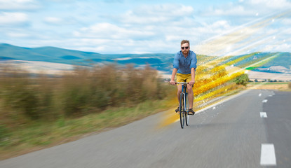 Fototapeta premium Young riding bicycle in nature