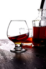 Glass of splash whiskey with bottle.