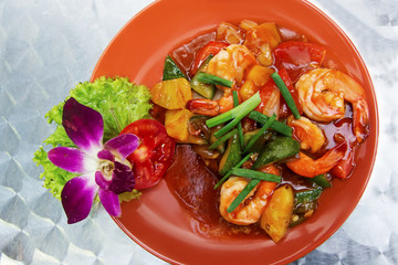 King prawns with vegetables in sweet and sour sauce on brashed metal table. Thai seafood. Thai  food concept. Top view