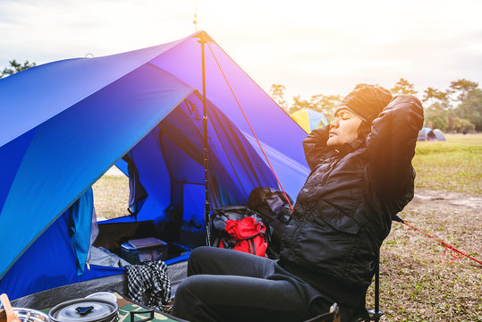 Asian man travel relax in the holiday. camping on the Mountain. sit relax on the chair. Thailand