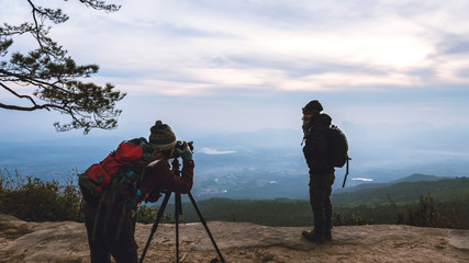 Fototapeta premium Photographer lover women and men asians travel relax in the holiday. Photograph mountain landscapes atmosphere in the morning. In the winter. In Thailand