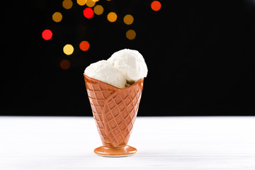 Ice cream on a white table on a black background. Space for text or design.