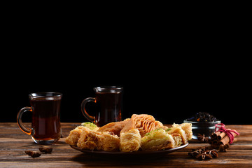Turkish sweet baklava on plate with Turkish tea. 