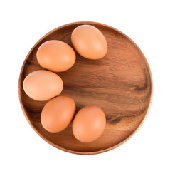 Five eggs in wooden plate isolated on white background, Top view.