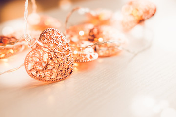 Rose gold colored heart shaped lighting background. Valentine's day, home decor ideas, love emotions concept