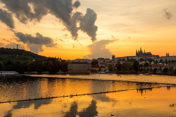 Fototapeta premium Sunset in Prague with Prague castle, Saint Vitus Cathedral, and the river Vltava.