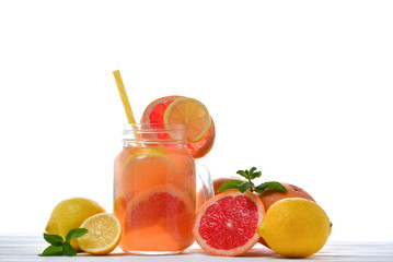 Summer detox drink with fresh fruits in glass jar.