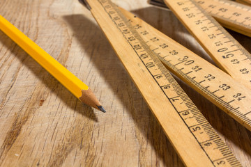 Measuring Sitck and Pencil on a Wooden Table