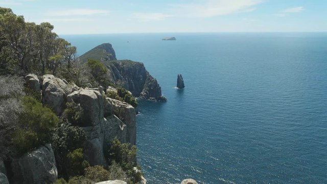 wide shot of the monument rock formation at cape hauy on the three capes track in tasmania, australia