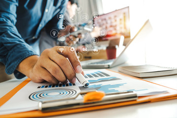 close up of businessman working with smart phone and laptop and digital tablet computer in modern office with virtual icon diagram