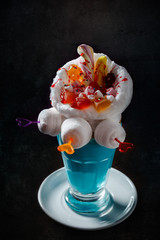blue milkshake with donuts on black background