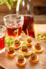 Tapas snack with sausage chorizo and green olive