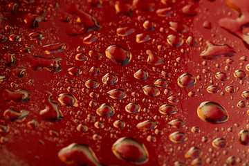 Colored water droplets on a gold background. Abstract liquid sprays