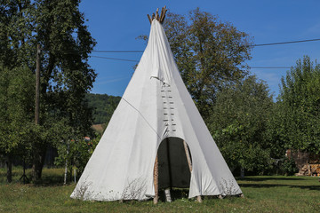 Wigwam in American style pitched in the field