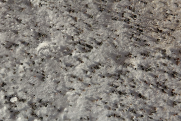 Background - Gravel on snowy pavement.