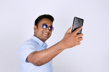 Young man operating smartphone