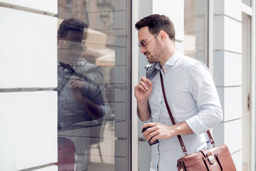 Young successful business man walking in the city.