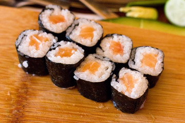 Preparation of Japanese rolls from salmon. Rolls on a wooden board