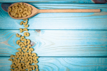 Pasta on wooden background. Diet and food concept.