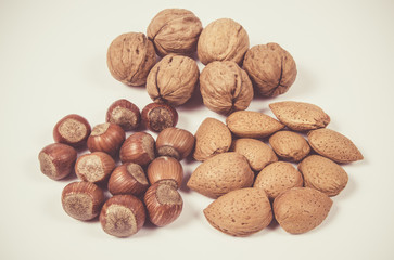 Different types of nuts in a shell on a white background.
