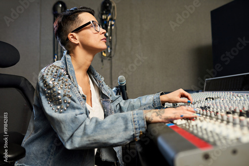 Concentrated Confident Hipster Female Sound Designer In Eyeglasses