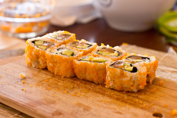 Japanese sushi and rolls with salmon, avocado, cucumber and flying fish caviar