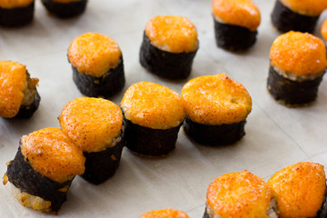 Japanese hot sushi and rolls with salmon, avocado, cucumber and flying fish caviar