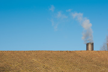 rooftop with a chimney and smoke