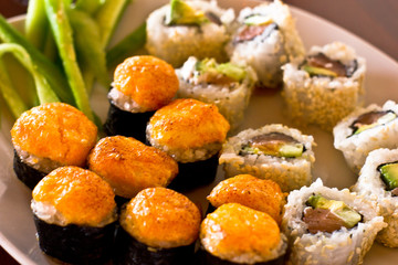 Japanese hot sushi and rolls with salmon, avocado, cucumber and flying fish caviar