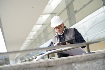 Fototapeta na wymiar Engineer on site checking project on digital tablet