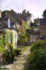Summer colour and picturesque old cottages of The Chipping Steps, Tetbury, Cotswolds, Gloucestershire, UK