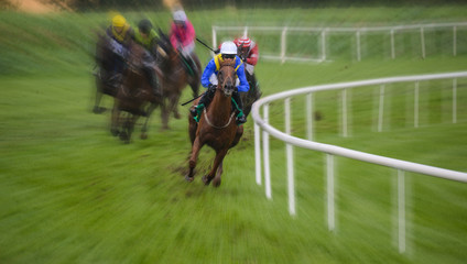 Galloping racehorse in the lead on the track turn,zoom motion blur effect