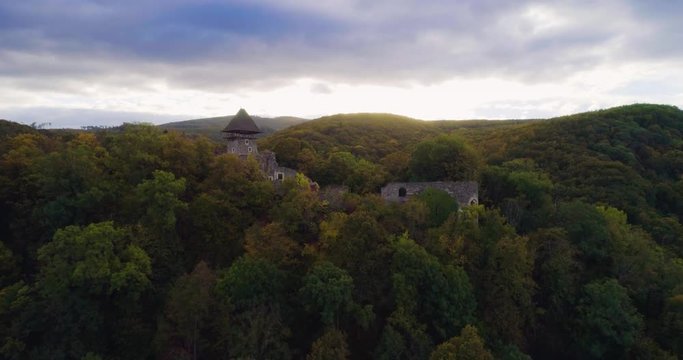 Aerial wiev: Incredible autumn sunrise against the ruins of an ancient castle, autumn paints