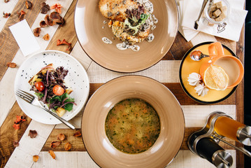 3-course lunch. Chef's specialty soup presented in restaurant on served table. Clouse up. Rustic style