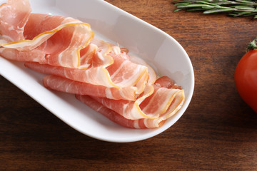 bacon sliced on a wooden background