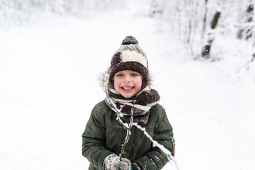 Fototapeta premium Little boy in winter park.