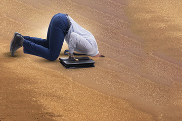 Businessman hiding his head in sand escaping from problems