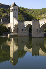 Fototapeta na wymiar Europe, France, Midi Pyrenees, Lot, Cahors, the historic Pont Valentre fortified bridge reflected in the Lot River