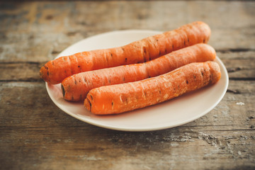 carrots on a white plate - peel and grate