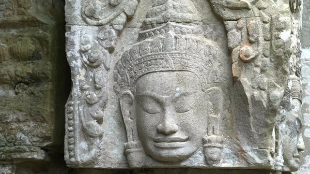 pan of a beautifully carved stone face at preah khan temple near angkor wat, cambodia