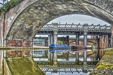 Several old bridges made of steel and concrete, near Castlefield, Manchester, England, reflecting...