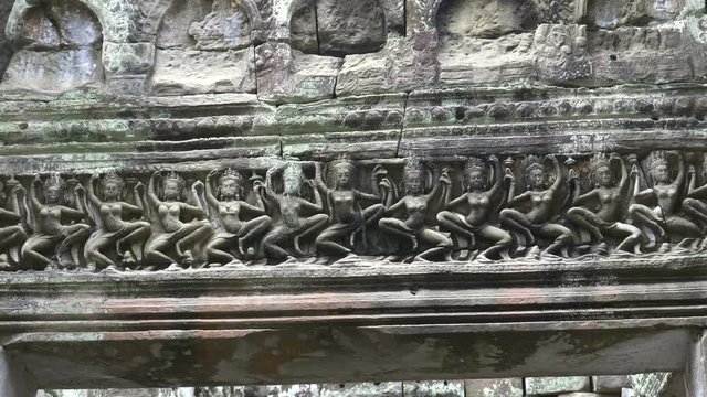 panning shot of dancers carved into a lintel of preah khan temple near angkor wat, cambodia