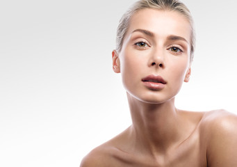 Beauty portrait of female face with natural skin. Beautiful blonde girl with Nude makeup isolated...