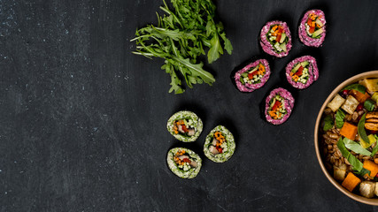Diet and vegetarian lunch food set - mix salad, spring rolls and granola on dark background. Flat top view, from above. Copy text in center banner.