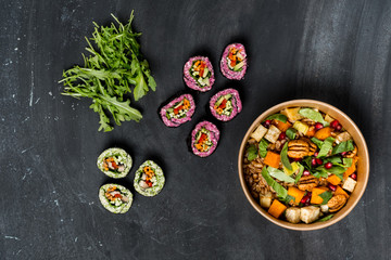 Diet and vegetarian lunch food set - mix salad, spring rolls and granola on dark background. Flat top view, from above. Copy text in center banner.
