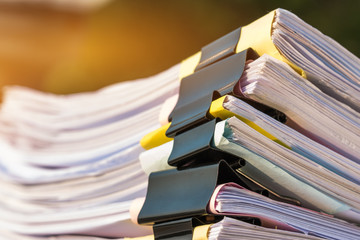 Unfinished documents stacks of paper files on office desk for report papers, piles of unfinish sheet achieves with clips. Document is written presented. Business offices busy concept.
