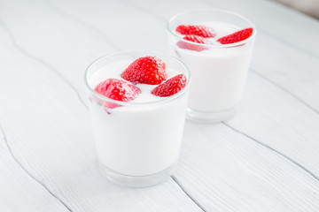 Eating healthy breakfast .Yogurt with strawberries  on the table