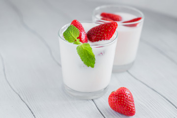 Eating healthy breakfast .Yogurt with strawberries  on the table