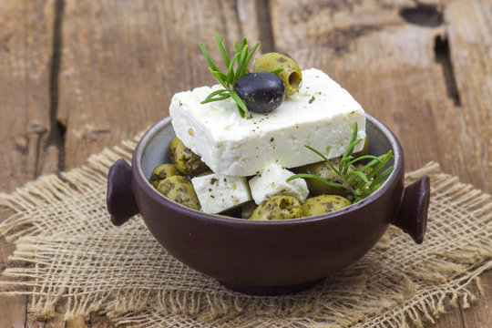 feta cheese and olives with herbs in olive oil